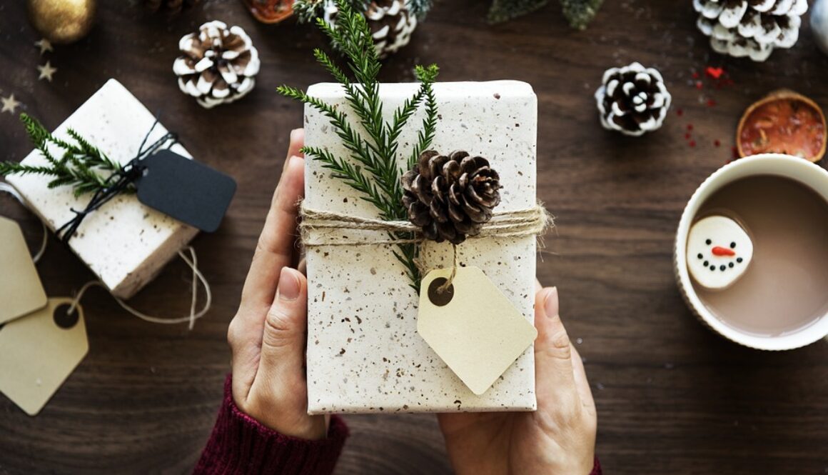 Festive wrapped box with decorations and cup of coffee