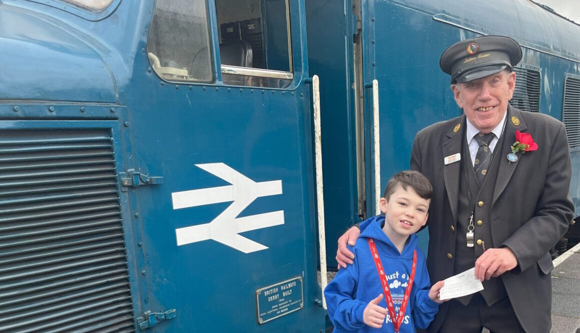 Young fundraiser Jacob Holden with Kidderminster station master Geoff Smith. Lesley Carr