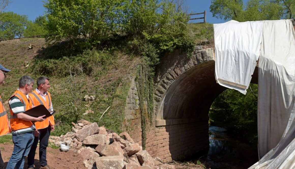 Gus Dunster, Antony Bartlam and Stuart Anderson MP inspect the damage at Mor Brook bridge. GARY ESSEX