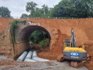 Installing the temporary culvert for the water course. CHRIS BOND
