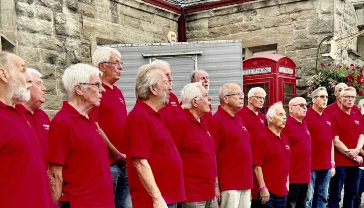 A male voice choir in full song outside the Railwayman's Arms at Bridgnorth station. DAVID BISSETT
