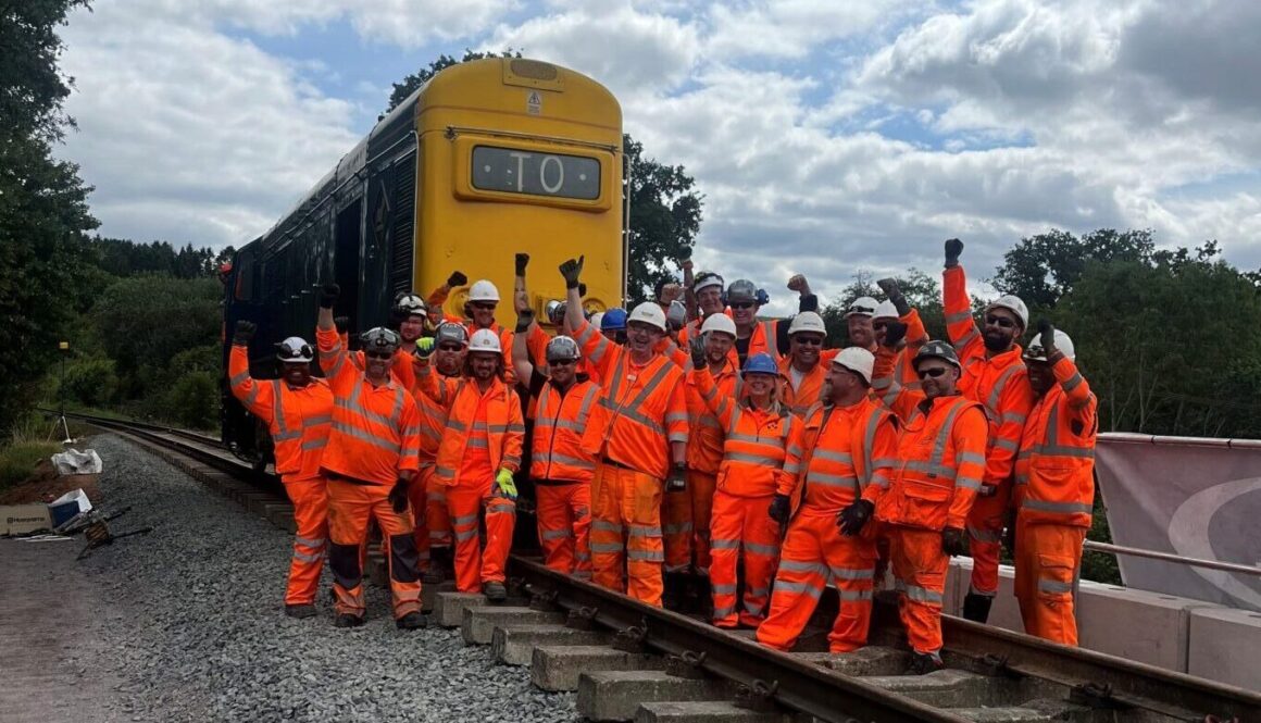 The Orange Army Volunteer All Stars with the first loco to cross the newly re-laid track at Mor Brook bridge. LESLEY CARR